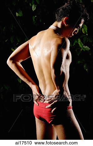 Man in swimming trunks, hands on hips, looking away View Large Photo Image Stock Image - Man in swimming trunks, hands on hips, looking away . Fotosearch