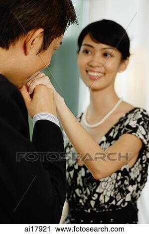 Man kissing hand of well dressed woman View Large Photo Image Stock Image - Man kissing hand of well dressed woman . Fotosearch