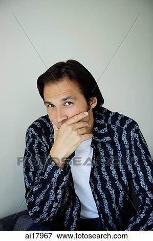 Man looking at camera, hand covering mouth, looking at camera View Large Photo Image Stock Photo - Man looking at camera, hand covering mouth, looking at camera. Fotosearch