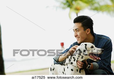 Man petting his Dalmatian dog View Large Photo Image Stock Photography - Man petting his Dalmatian dog . Fotosearch