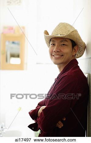 Man wearing hat, arms crossed, smiling at camera View Large Photo Image Stock Photo - Man wearing hat, arms crossed, smiling at camera. Fotosearch