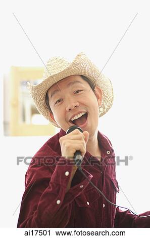 Man wearing hat, singing into microphone View Large Photo Image Stock Image - Man wearing hat, singing into microphone . Fotosearch