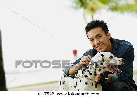 Man with Dalmatian dog, smiling at camera View Large Photo Image Stock Photograph - Man with Dalmatian dog, smiling at camera . Fotosearch