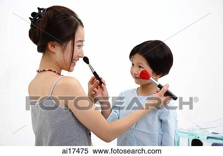 Mother and daughter applying make up on each other View Large Photo Image Stock Photography - Mother and daughter applying make up on each other . Fotosearch