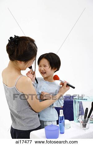 Mother and young daughter applying make-up on each other View Large Photo Image Stock Photo - Mother and young daughter applying make-up on each other . Fotosearch