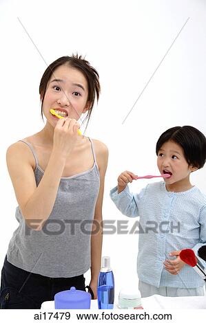 Mother and young daughter brushing teeth View Large Photo Image Stock Photo - Mother and young daughter brushing teeth . Fotosearch