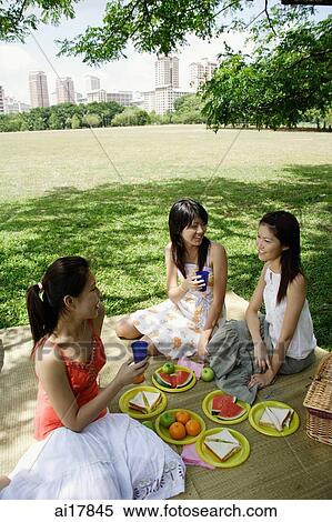 Three women in park, having a picnic View Large Photo Image Stock Photography - Three women in park, having a picnic . Fotosearch