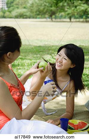 Two women having a picnic View Large Photo Image Stock Photo - Two women having a picnic . Fotosearch