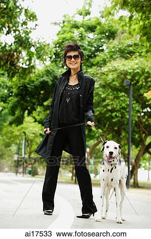 Woman dressed in black, with Dalmatian View Large Photo Image Stock Image - Woman dressed in black, with Dalmatian. Fotosearch