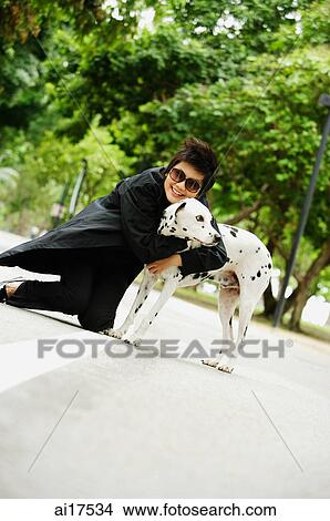 Woman embracing Dalmatian View Large Photo Image Picture - Woman embracing Dalmatian . Fotosearch
