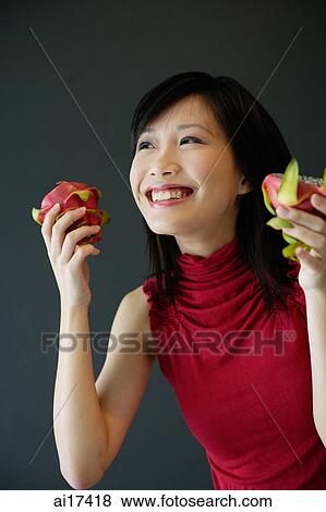Woman holding cut dragon fruit View Large Photo Image Stock Photo - Woman holding cut dragon fruit . Fotosearch
