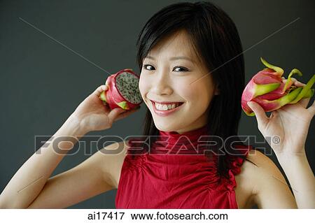 Woman holding dragon fruit View Large Photo Image Stock Photo - Woman holding dragon fruit . Fotosearch