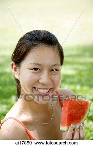 Woman holding slice of watermelon View Large Photo Image Stock Image - Woman holding slice of watermelon. Fotosearch