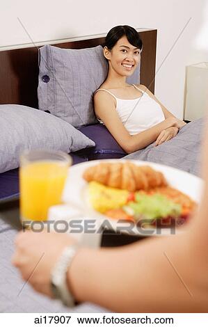 Woman in bed, waiting for breakfast tray View Large Photo Image Stock Photo - Woman in bed, waiting for breakfast tray . Fotosearch