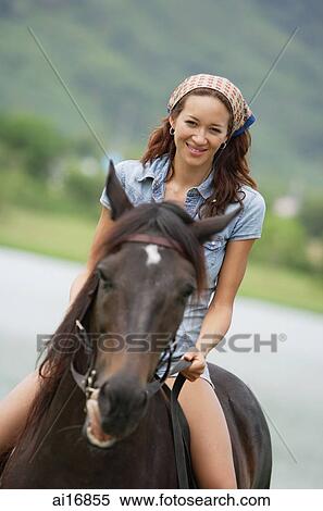 Woman sitting on horse, smiling View Large Photo Image Stock Photography - Woman sitting on horse, smiling . Fotosearch