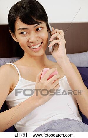 Woman using mobile phone, holding ring box View Large Photo Image Stock Image - Woman using mobile phone, holding ring box . Fotosearch