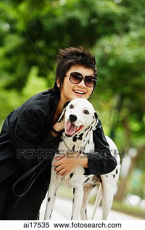 Woman with sunglasses embracing Dalmatian View Large Photo Image Stock Photography - Woman with sunglasses embracing Dalmatian . Fotosearch