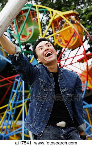 Young man at playground, smiling View Large Photo Image Stock Image - Young man at playground, smiling . Fotosearch