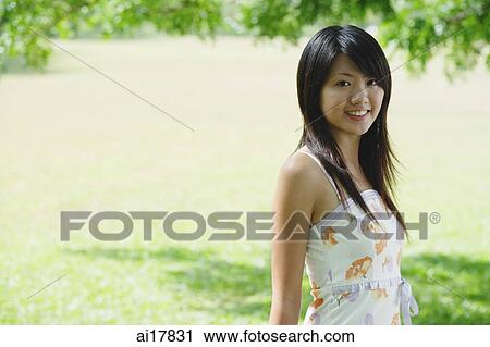 Young woman smiling at camera View Large Photo Image Stock Image - Young woman smiling at camera. Fotosearch