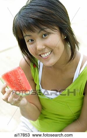 Young woman with slice of watermelon, smiling at camera View Large Photo Image Stock Image - Young woman with slice of watermelon, smiling at camera . Fotosearch