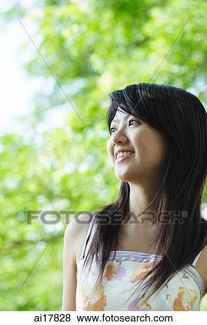 Young woman with straight hair, smiling, looking away View Large Photo Image Stock Photo - Young woman with straight hair, smiling, looking away . Fotosearch
