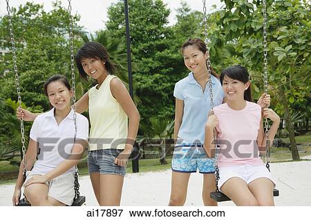 Stock Photo - Young women in playground, smiling at camera . Fotosearch