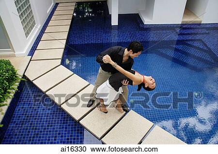 Couple by swimming pool, dancing, man dipping woman View Large Photo Image Stock Image - Couple by swimming pool, dancing, man dipping woman . Fotosearch