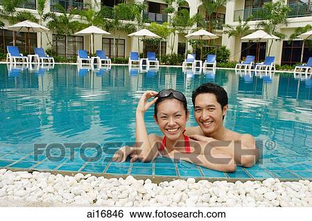 Couple in swimming pool, smiling at camera View Large Photo Image Stock Photograph - Couple in swimming pool, smiling at camera . Fotosearch