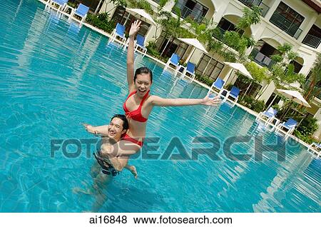 Couple in swimming pool, woman sitting on mans shoulders View Large Photo Image Stock Photo - Couple in swimming pool, woman sitting on mans shoulders . Fotosearch