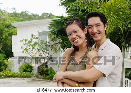 Couple looking at camera, smiling, man embracing woman View Large Photo Image Stock Photo - Couple looking at camera, smiling, man embracing woman . Fotosearch