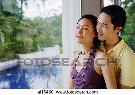 Couple looking through a window View Large Photo Image Stock Image - Couple looking through a window . Fotosearch