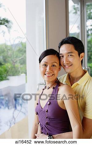 Couple next to a window, looking at camera, portrait View Large Photo Image Stock Image - Couple next to a window, looking at camera, portrait . Fotosearch