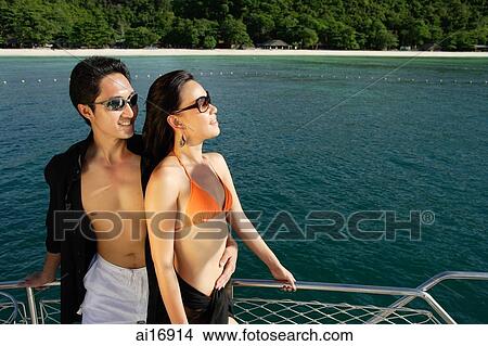 Picture - Couple on boat deck, looking away . Fotosearch