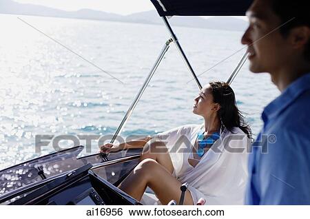 Stock Photograph - Couple on yacht, looking away . Fotosearch