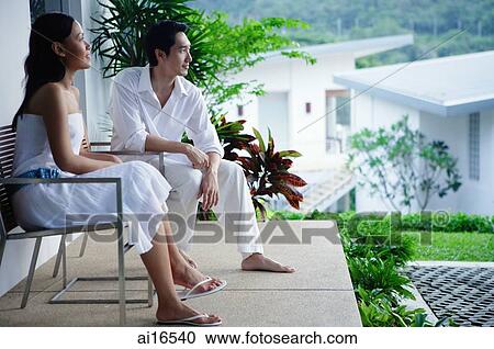 Couple sitting on patio, both looking away View Large Photo Image Stock Image - Couple sitting on patio, both looking away. Fotosearch