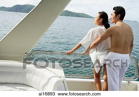 Couple standing on stern of yacht View Large Photo Image Stock Image - Couple standing on stern of yacht . Fotosearch