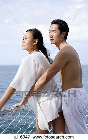 Couple standing on yacht, leaning on railing View Large Photo Image Stock Photo - Couple standing on yacht, leaning on railing . Fotosearch