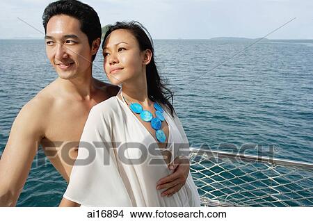 Couple standing on yacht View Large Photo Image Picture - Couple standing on yacht . Fotosearch