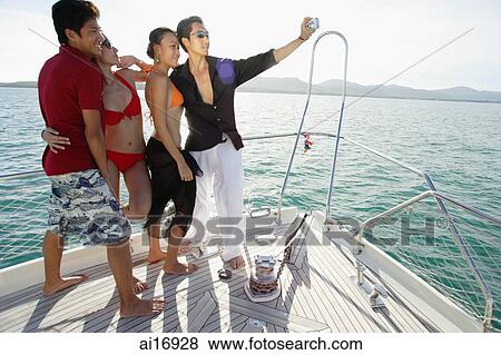 Couples on boat deck, taking a picture View Large Photo Image Stock Photo - Couples on boat deck, taking a picture . Fotosearch