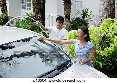 Man and woman washing car, man with water hose View Large Photo Image Picture - Man and woman washing car, man with water hose . Fotosearch