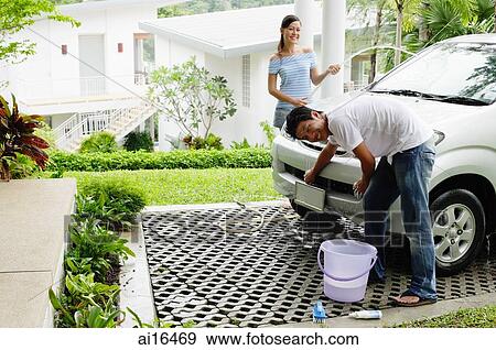Man and woman washing car, smiling at camera View Large Photo Image Stock Photo - Man and woman washing car, smiling at camera . Fotosearch