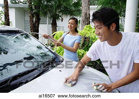 Stock Photo - Man and woman washing car, woman with water hose . Fotosearch