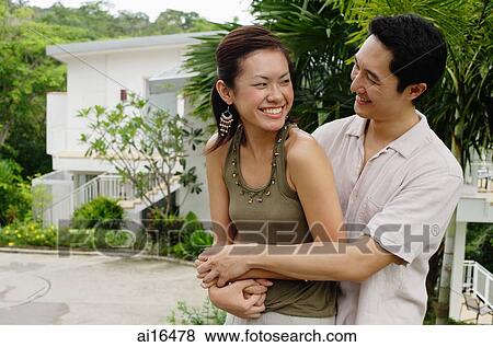 Man embracing woman, both smiling View Large Photo Image Stock Photo - Man embracing woman, both smiling . Fotosearch