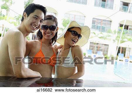 Two women and one man in swimwear, smiling View Large Photo Image Stock Image - Two women and one man in swimwear, smiling . Fotosearch