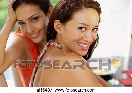 Two women smiling at camera View Large Photo Image Stock Photo - Two women smiling at camera . Fotosearch