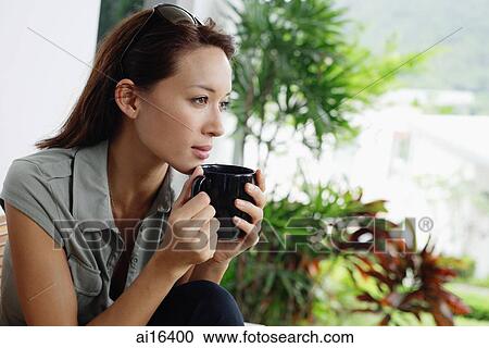 Woman holding coffee mug, looking away View Large Photo Image Stock Image - Woman holding coffee mug, looking away . Fotosearch