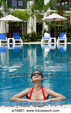 Woman in swimming pool, wearing sunglasses View Large Photo Image Stock Photo - Woman in swimming pool, wearing sunglasses . Fotosearch