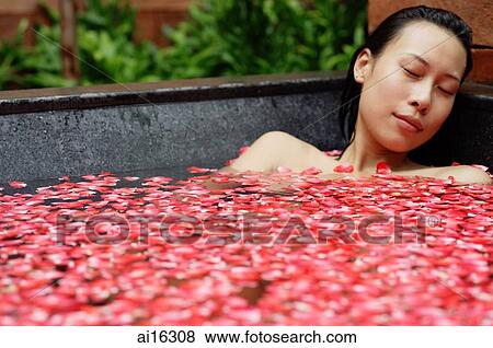 Woman in tub with floating rose petals, eyes closed View Large Photo Image Stock Photo - Woman in tub with floating rose petals, eyes closed. Fotosearch