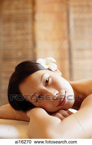 Woman leaning head on arms, looking at camera View Large Photo Image Stock Image - Woman leaning head on arms, looking at camera . Fotosearch