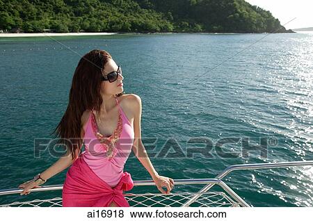 Woman on boat, leaning on railing, looking away View Large Photo Image Stock Photo - Woman on boat, leaning on railing, looking away . Fotosearch
